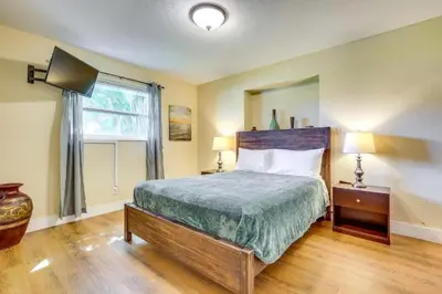 a bedroom with a large bed and a window at Spacious House near Fort Lauderdale - Minutes from Beach in Plantation