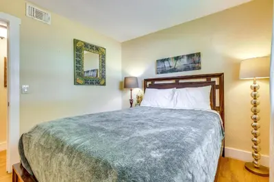 a bedroom with a bed and two pictures on the wall at Spacious House near Fort Lauderdale - Minutes from Beach in Plantation