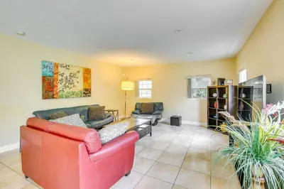 a living room with a red couch and chairs at Spacious House near Fort Lauderdale - Minutes from Beach in Plantation