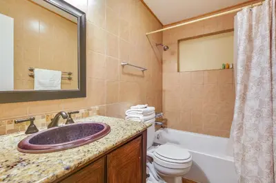 a bathroom with a sink and a toilet and a mirror at Spacious House near Fort Lauderdale - Minutes from Beach in Plantation