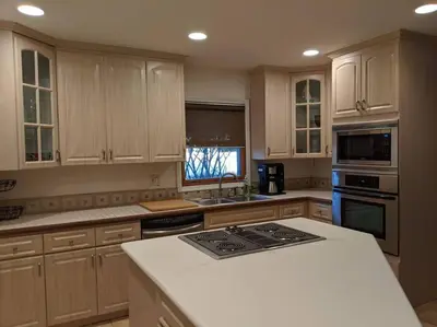 a kitchen with wooden cabinets and a white counter top at Spacious House in Fort Lauderdale - Minutes from Beach in Fort Lauderdale