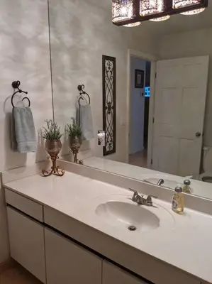 a bathroom with a sink and a large mirror at Spacious House in Fort Lauderdale - Minutes from Beach in Fort Lauderdale