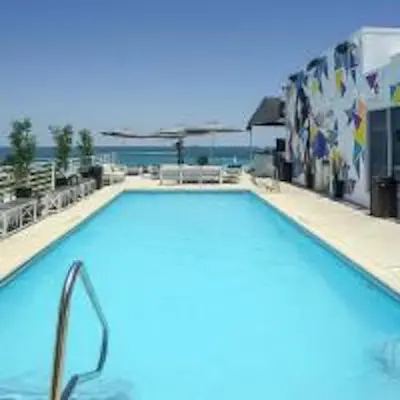 a swimming pool with a view of the ocean at Congress Ocean Drive in Miami Beach