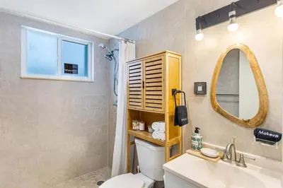 a bathroom with a toilet and a sink and a mirror at The Brickell Hideout - Charming/Cozy/Central in Miami