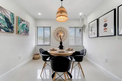 a dining room with a table and chairs at Westchester Garden in Miami