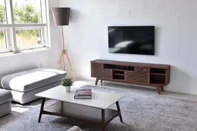 a living room with a tv and a coffee table at 515-Trendy 2Bd2Ba Midtown HUGE private patio! in Miami