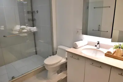 a bathroom with a toilet and a shower and a sink at 515-Trendy 2Bd2Ba Midtown HUGE private patio! in Miami