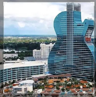 a large building with a guitar shaped building at Amazing 5 Bedroom Pool Home - Minimum 28 days Stay Only Great Location! in Miramar