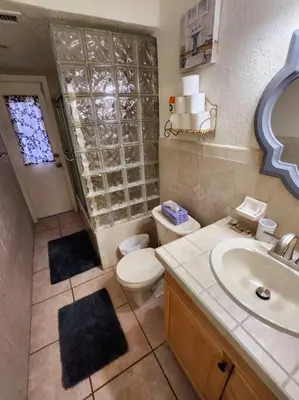 a bathroom with a toilet and a sink at Amazing 5 Bedroom Pool Home - Minimum 28 days Stay Only Great Location! in Miramar