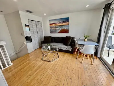 a living room with a couch and a table at Seaside Serenity Duplex in Miami Beach