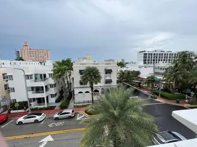 a city street with cars parked in a parking lot at Seaside Serenity Duplex in Miami Beach