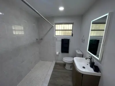 a bathroom with a toilet and a sink at Fully equipped Apartments with parking near Cocowalk in Miami