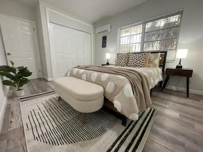 a bedroom with a bed and a chair and a window at Fully equipped Apartments with parking near Cocowalk in Miami