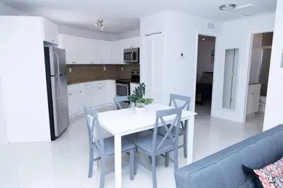 a kitchen and dining room with a white table and chairs at Apartments Little Habana near calle 8 in Miami