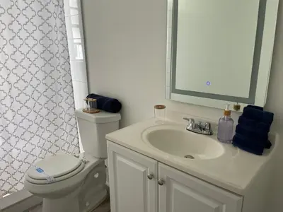 a bathroom with a sink and a toilet and a mirror at Remodeled Little Havanna Apartments great location in Miami