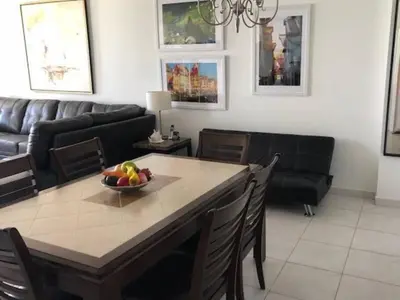 a living room with a table with a bowl of fruit on it at Beautiful Pavilion in Miami Beach