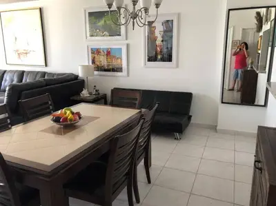 a living room with a table with a bowl of fruit on it at Beautiful Pavilion in Miami Beach
