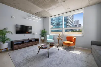 a living room with a couch and a tv at 516-2Bd2Ba Midblock Apartment FREE parking in Miami