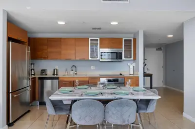 a kitchen with a table and chairs in a kitchen at 516-2Bd2Ba Midblock Apartment FREE parking in Miami