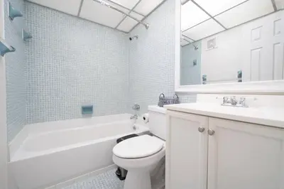 a white bathroom with a toilet and a sink at Enjoy Fully Equipped 2BR Condo Near The Beach in Sunny Isles Beach