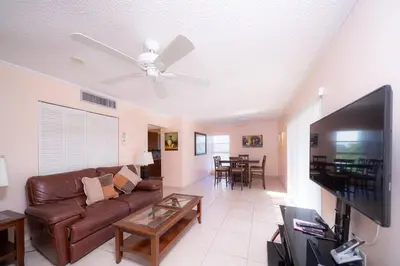 a living room with a couch and a flat screen tv at Enjoy Fully Equipped 2BR Condo Near The Beach in Sunny Isles Beach
