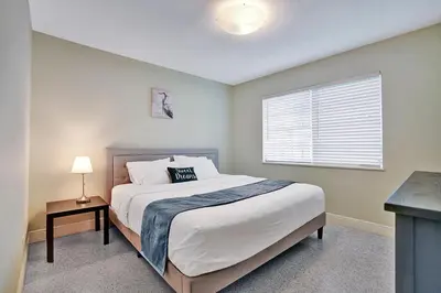 a bedroom with a large bed and a window at Best Area Spacious 4BR Heated Pool Mins To Beach in Hollywood