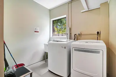 a laundry room with a washing machine and a sink at Best Area Spacious 4BR Heated Pool Mins To Beach in Hollywood