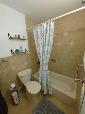 a bathroom with a toilet and a shower curtain at Walk to Hard Rock ~ Amazing 5 Star Home Away From Home! in Miami Gardens