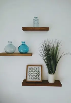 two shelves with vases and a plant on a wall at Walk to Hard Rock ~ Amazing 5 Star Home Away From Home! in Miami Gardens