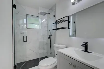 a bathroom with a shower and a toilet and a sink at MiamiVice Las Olas Near Beach and Park w Fire Pit in Fort Lauderdale