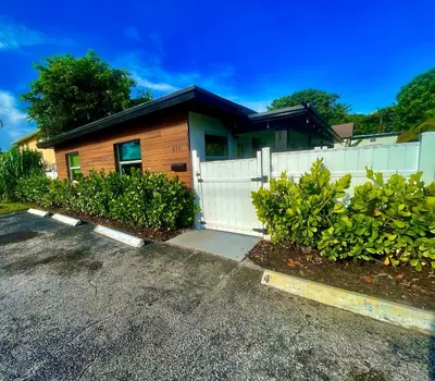 a house with a white fence and a driveway at MiamiVice Las Olas Near Beach and Park w Fire Pit in Fort Lauderdale