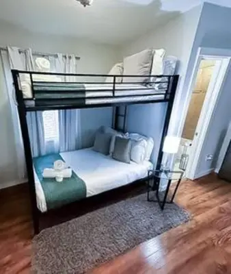 a bedroom with a bunk bed with white sheets at Charming 4BR Home with Heated Pool in Hollywood in Hollywood
