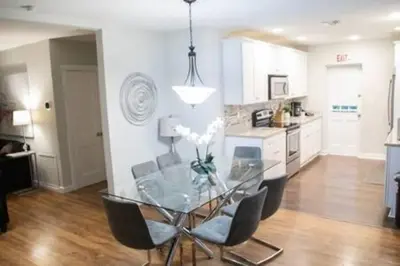 a dining room with a glass table and chairs at Charming 4BR Home with Heated Pool in Hollywood in Hollywood