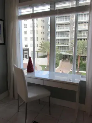 a window with a desk and a chair in front of it at Ocean Breeze Studio With Parking By The Beach in Miami Beach