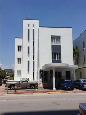 a truck parked in front of a white building at Ocean Breeze Studio With Parking By The Beach in Miami Beach