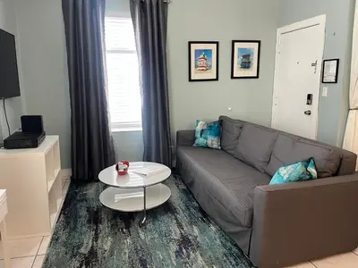 a living room with a couch and a table at Ocean Breeze Studio With Parking By The Beach in Miami Beach