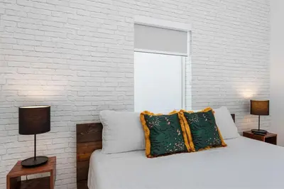 a bedroom with a bed and a brick wall at The Wellness Retreat- Amazing Amenities Near Beach in Hollywood