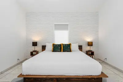 a bedroom with a large white bed with two lamps at The Wellness Retreat- Amazing Amenities Near Beach in Hollywood
