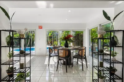 a dining room with a table with chairs and plants at The Wellness Retreat- Amazing Amenities Near Beach in Hollywood