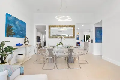 a dining room and living room with a table and chairs at Sea La Vie FL in Fort Lauderdale