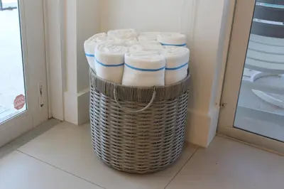 a basket full of folded towels in a bathroom at Sea La Vie FL in Fort Lauderdale