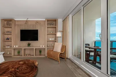 a living room with a television and a room with a table at 1 Hotel King Suite 1BR 1 5BA in Miami Beach