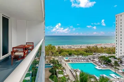 a view of the pool and ocean from the balcony of a hotel at 1 Hotel King Suite 1BR 1 5BA in Miami Beach