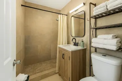 a bathroom with a toilet and a sink and a shower at Central Miami Oasis, Near Brickell, Grove & Little Havana in Miami
