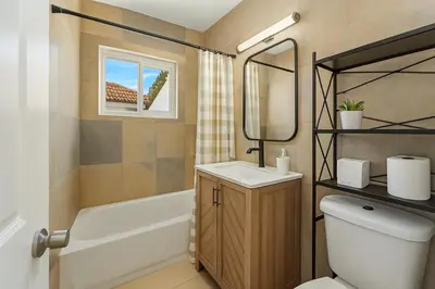 a bathroom with a toilet and a sink and a tub at Central Miami Oasis, Near Brickell, Grove & Little Havana in Miami
