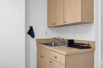 a kitchen with a sink and a counter top at Sunny Miami Stay - Pool - BBQ - Centrally Located in Miami