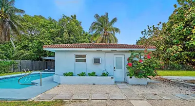 a small house next to a swimming pool at Sunny Miami Stay - Pool - BBQ - Centrally Located in Miami