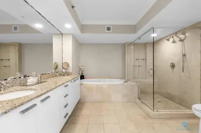 a bathroom with two sinks and a shower and a tub at Amazing View Beachfront Resort Luxury Amenities in Hallandale Beach