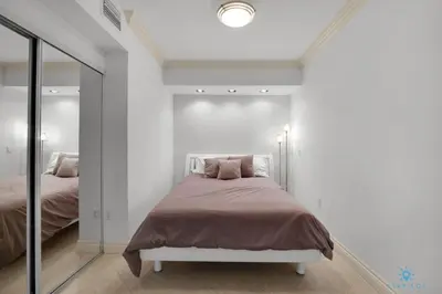 a bedroom with a bed and a mirror at Amazing View Beachfront Resort Luxury Amenities in Hallandale Beach