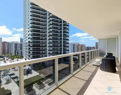 a balcony with a view of a tall building at Amazing View Beachfront Resort Luxury Amenities in Hallandale Beach